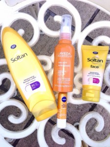 A picture of Soltan SPF for body, Soltan SPF for face, Aveda SPF for hair an Nivea lip sunscreen