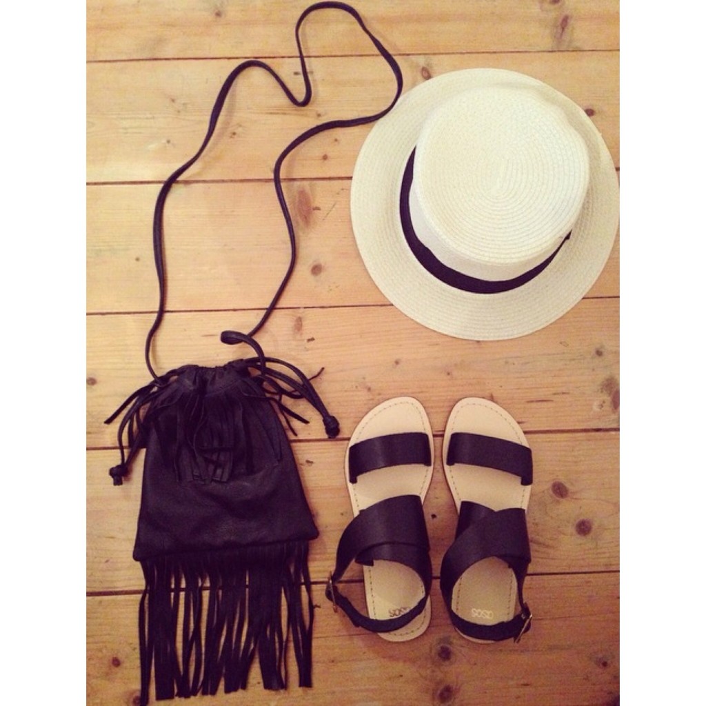 A picture of a straw hat, black sandals and black fringed bag from ASOS