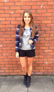 A picture of a girl in black Zara shorts and blue stripe jacket
