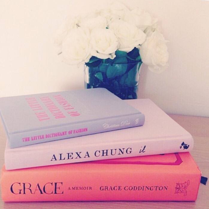 A picture of fashion books and white roses