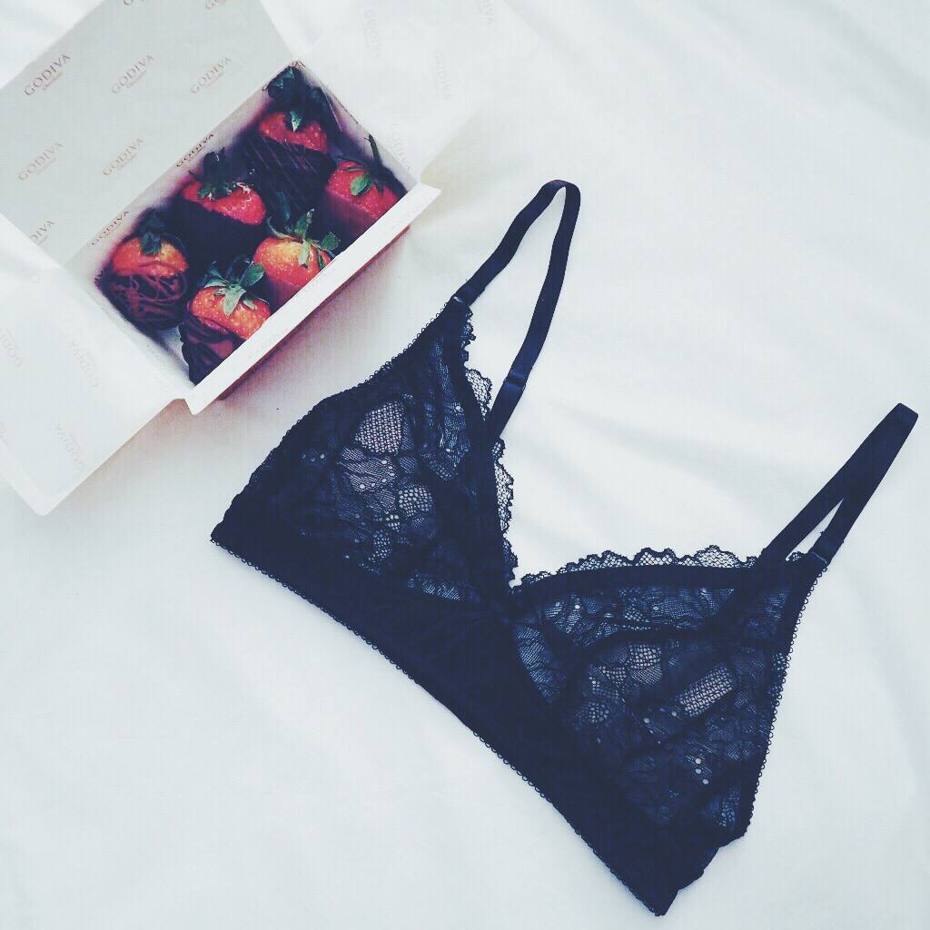 A picture of Godiva strawberries and a black lace bralet
