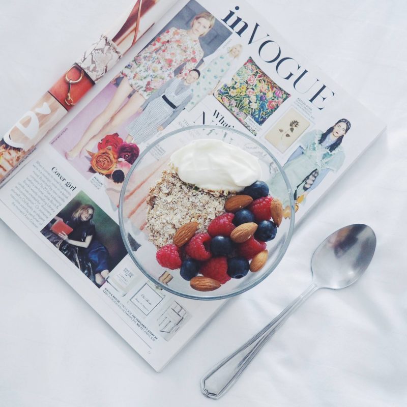 A picture of Vogue magazine, muesli, yoghurt, almonds and fruit