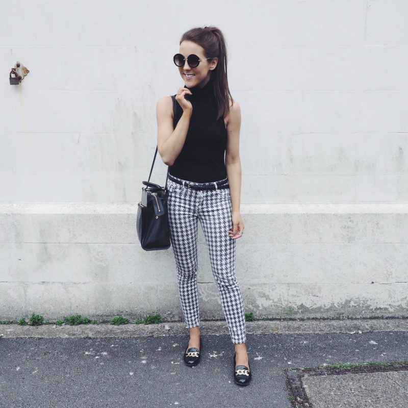 A picture of a fashion blogger wearing Zara dogtooth trousers, Radley handbag, H&M roll neck top and River Island loafers