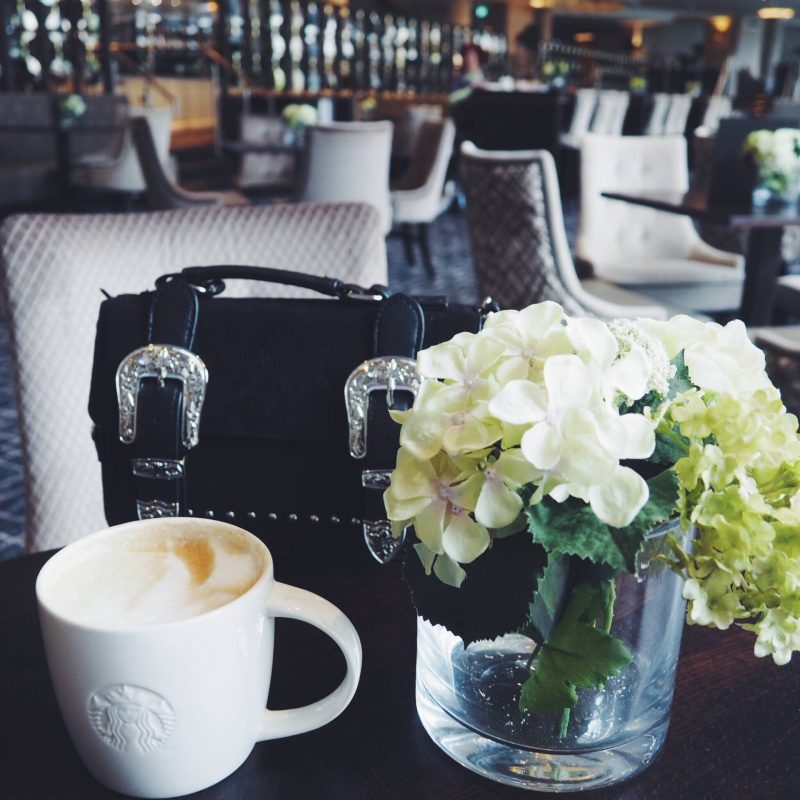 Flowers, Starbucks coffee and a black bag
