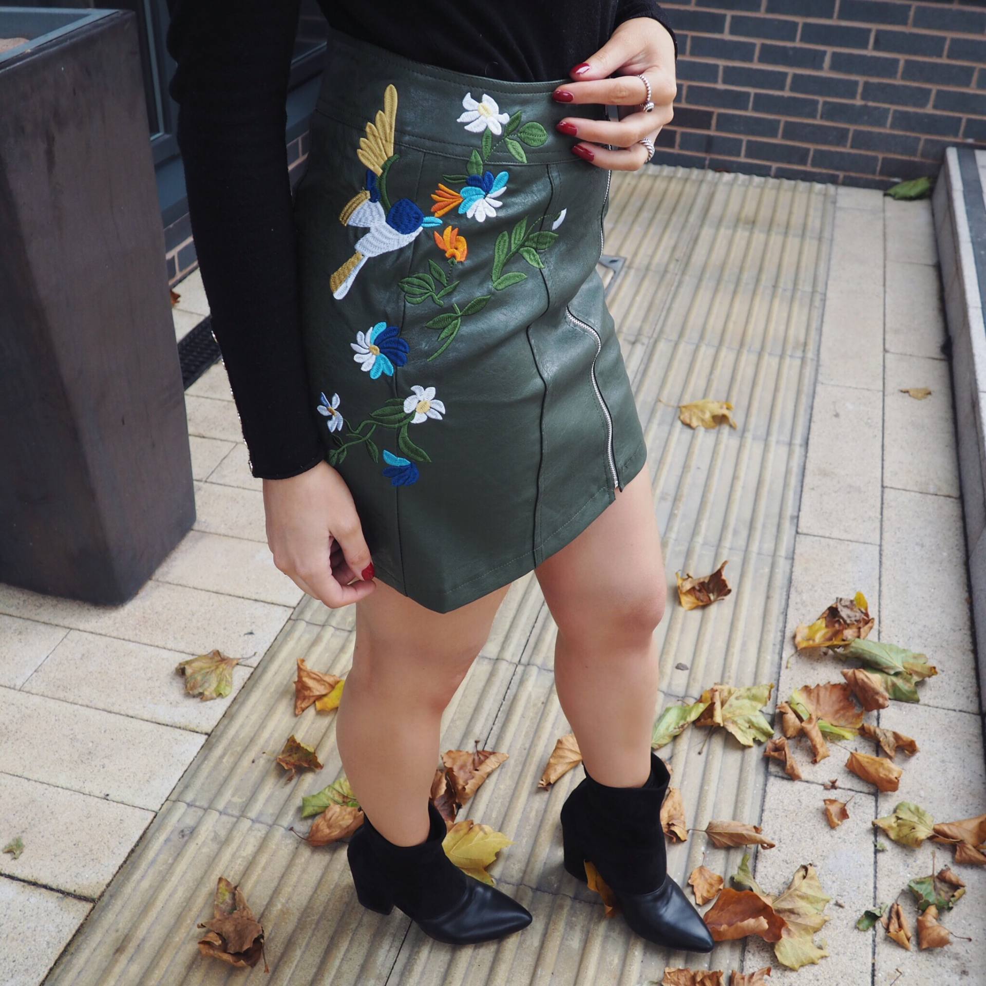 Skirt with embroidery, black jumper and ankle boots